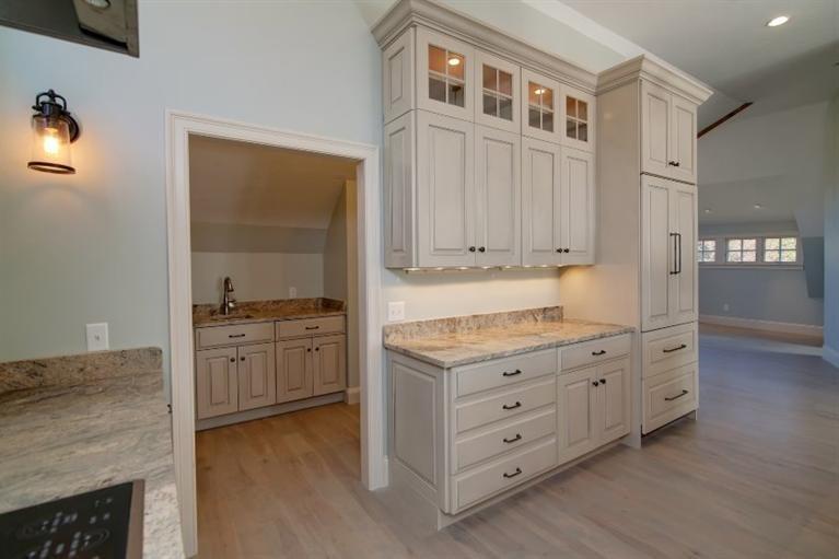 49-55 Rocky Point Road Bourne, MA 02532 - Photo 11 of 42 a kitchen with granite countertop a sink cabinets and wooden floor
