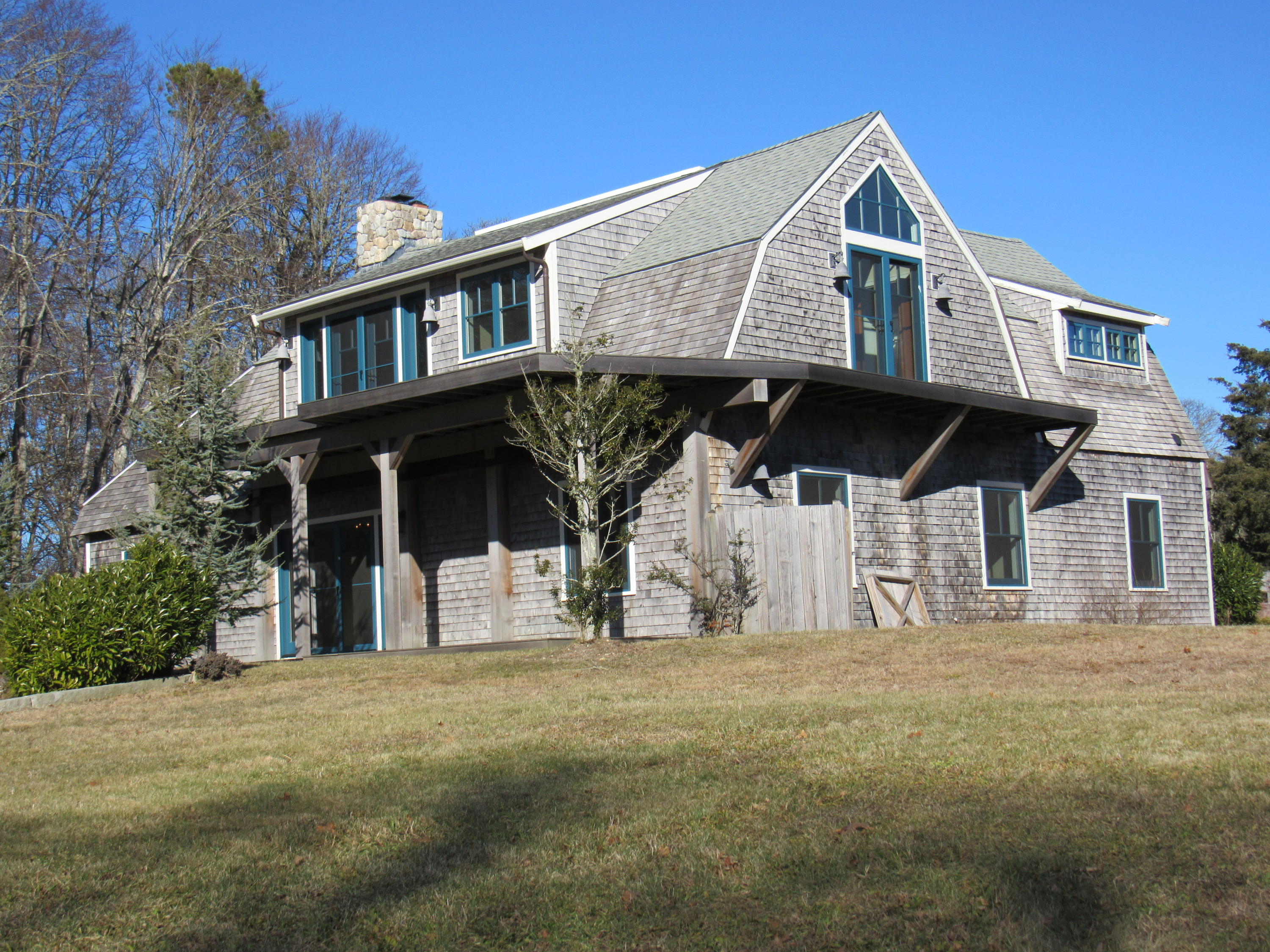 49-55 Rocky Point Road Bourne, MA 02532 - Photo 2 of 42 a front view of a house with large trees