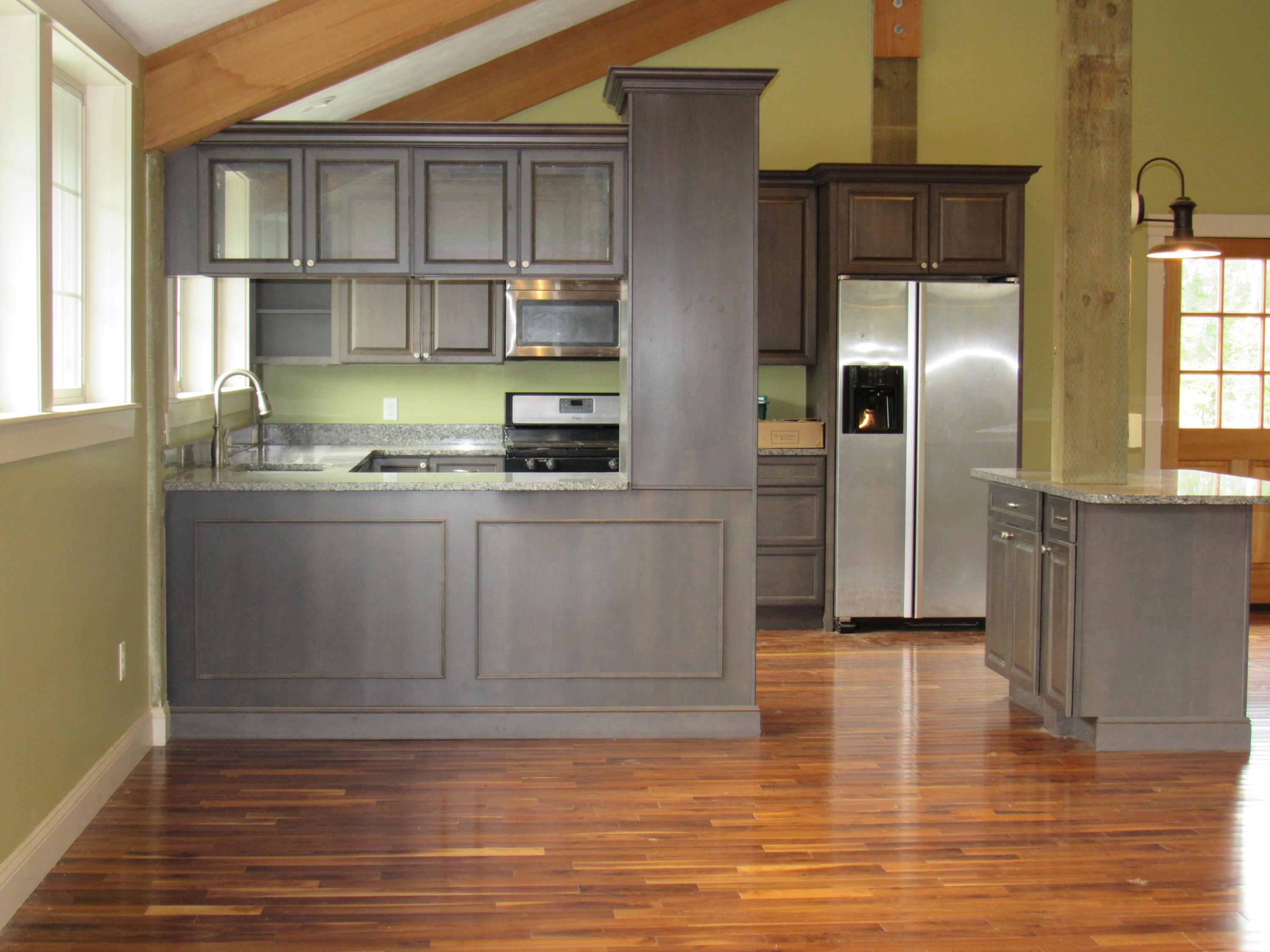49-55 Rocky Point Road Bourne, MA 02532 - Photo 31 of 42 a kitchen with stainless steel appliances granite countertop a refrigerator a sink a stove and cabinets