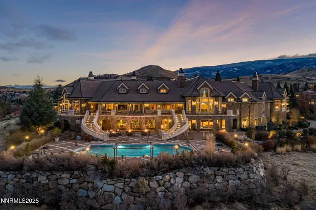 a view of a house with a big yard and a car park