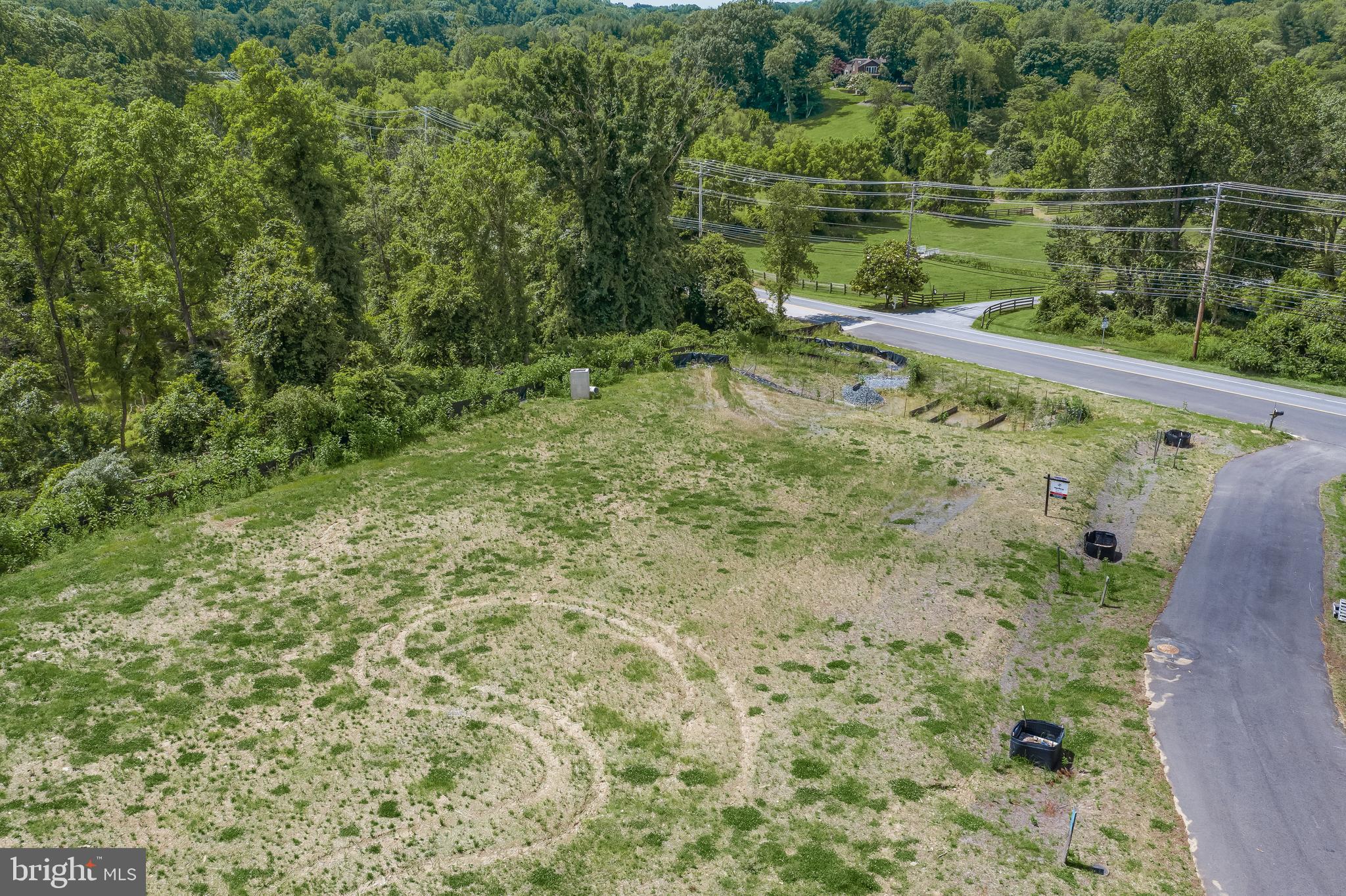 Lot 2 Guilford Road Clarksville, MD 21029 - Photo 13 of 32 a view of a lush green forest with a bench and trees