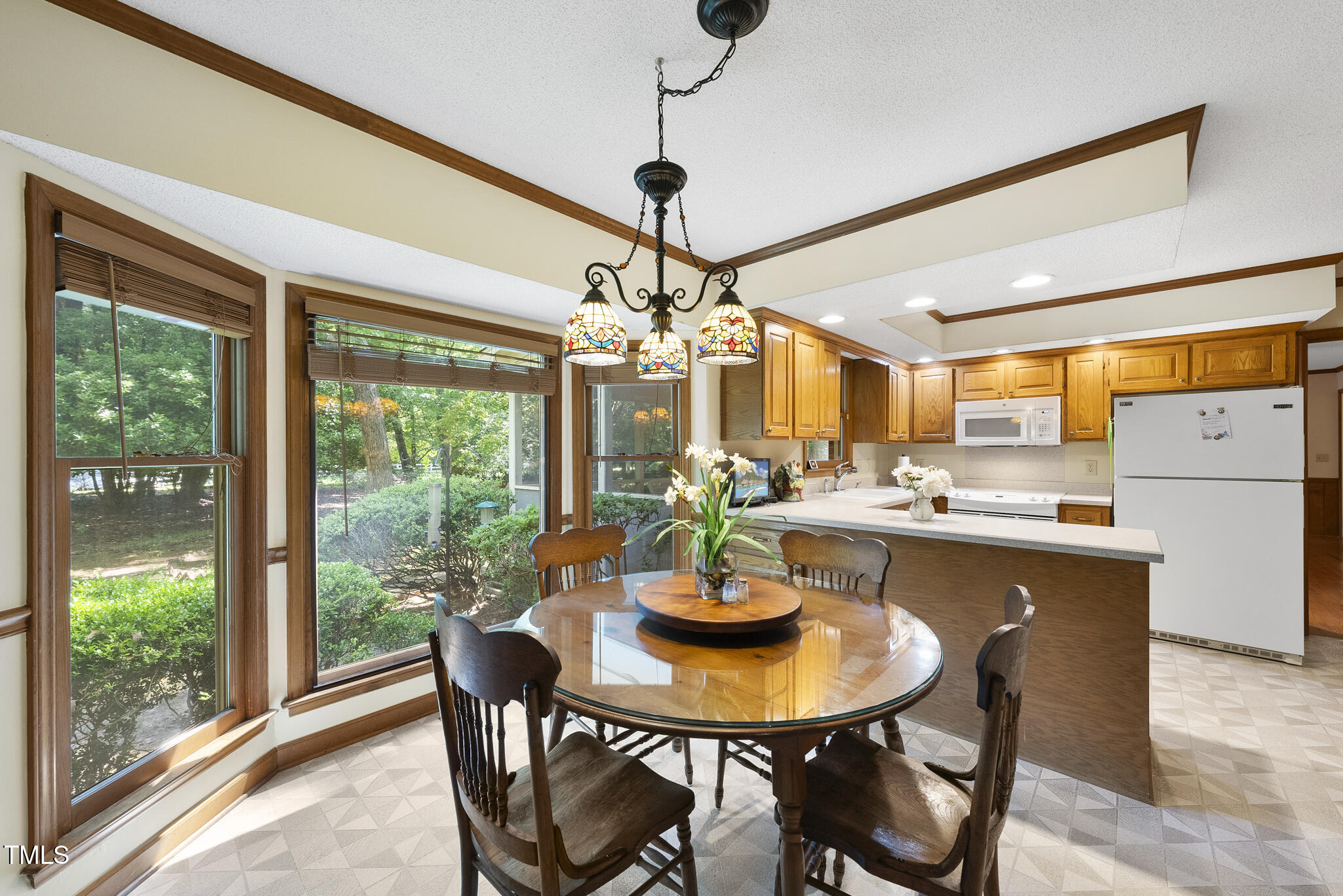 2001 Lovdal Drive Raleigh, NC 27613 - Photo 10 of 42 a dining room with furniture a chandelier and window