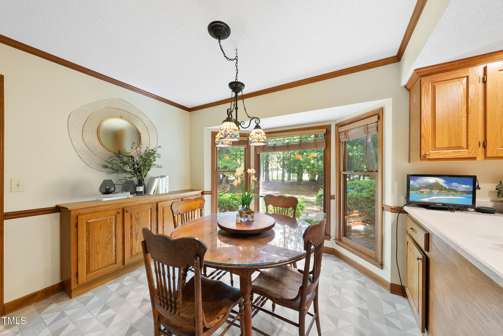 2001 Lovdal Drive Raleigh, NC 27613 - Photo 11 of 42 a dining room with furniture a chandelier and wooden floor