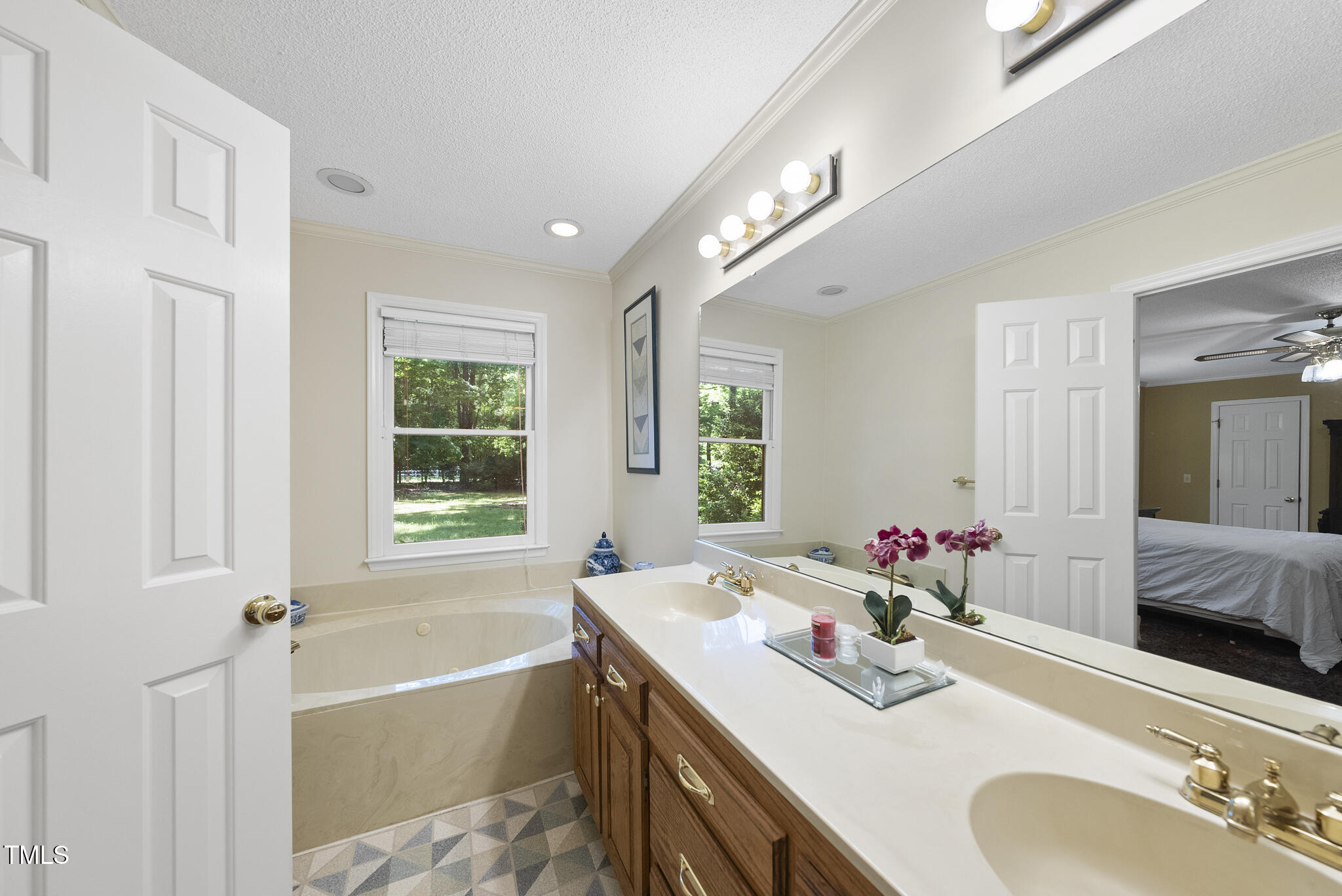2001 Lovdal Drive Raleigh, NC 27613 - Photo 17 of 42 a bathroom with a tub sink and mirror