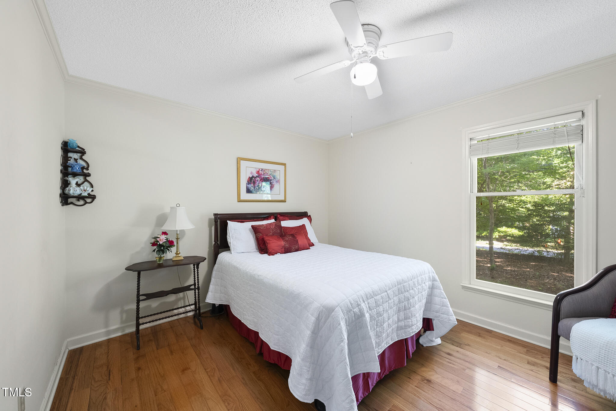 2001 Lovdal Drive Raleigh, NC 27613 - Photo 22 of 42 a bedroom with a bed and a chandelier