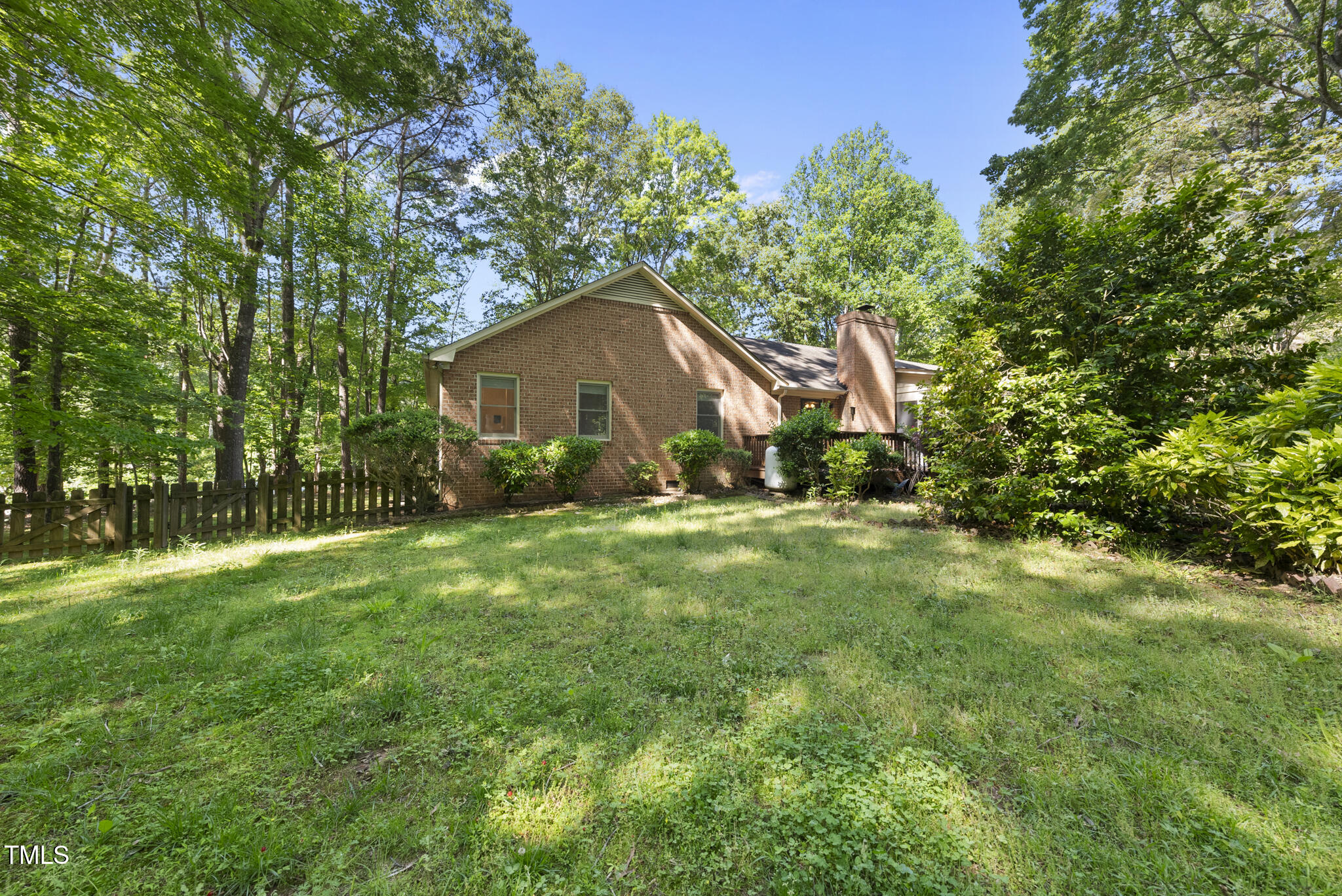 2001 Lovdal Drive Raleigh, NC 27613 - Photo 30 of 42 a backyard of a house with lots of green space