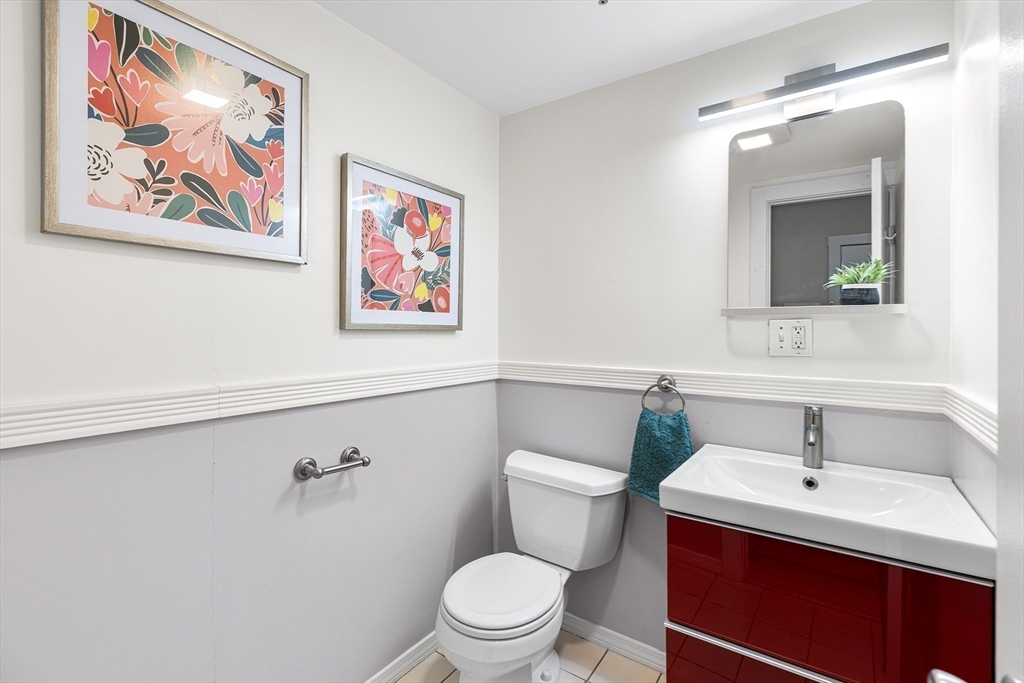 398 Broadway, Unit 2A Somerville, MA 02145 - Photo 21 of 25 a bathroom with a toilet sink and mirror