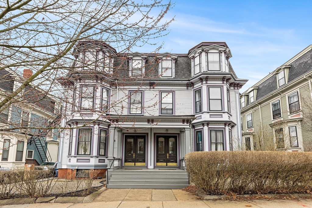 398 Broadway, Unit 2A Somerville, MA 02145 - Photo 23 of 25 a front view of a residential apartment building with a yard