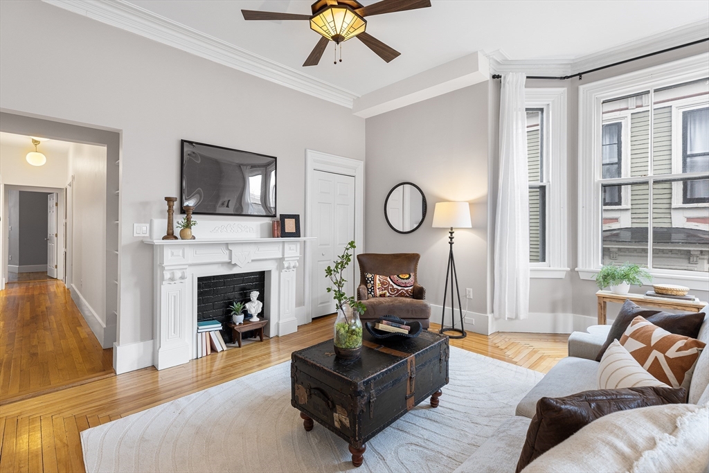 398 Broadway, Unit 2A Somerville, MA 02145 - Photo 3 of 25 a living room with furniture a fireplace and a flat screen tv