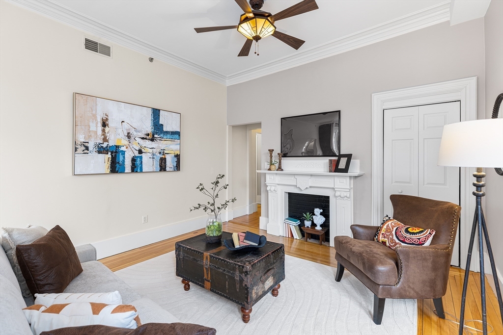 398 Broadway, Unit 2A Somerville, MA 02145 - Photo 4 of 25 a living room with furniture and a fireplace