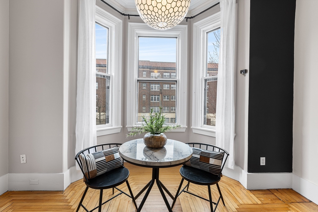 398 Broadway, Unit 2A Somerville, MA 02145 - Photo 5 of 25 a living room with furniture and a window