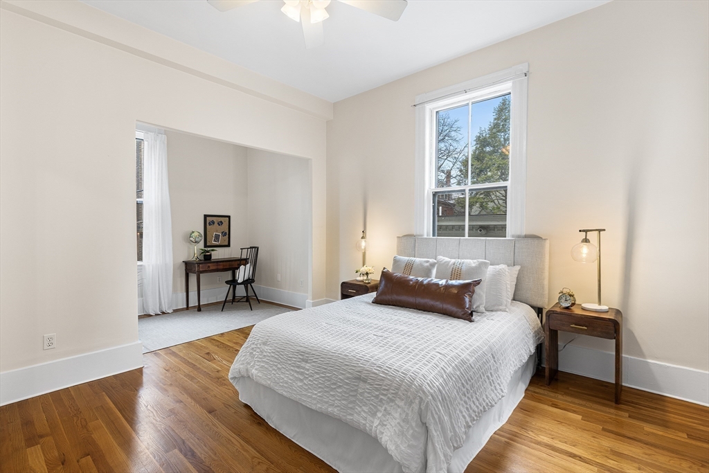 398 Broadway, Unit 2A Somerville, MA 02145 - Photo 10 of 25 a bed room with a bed and a chair