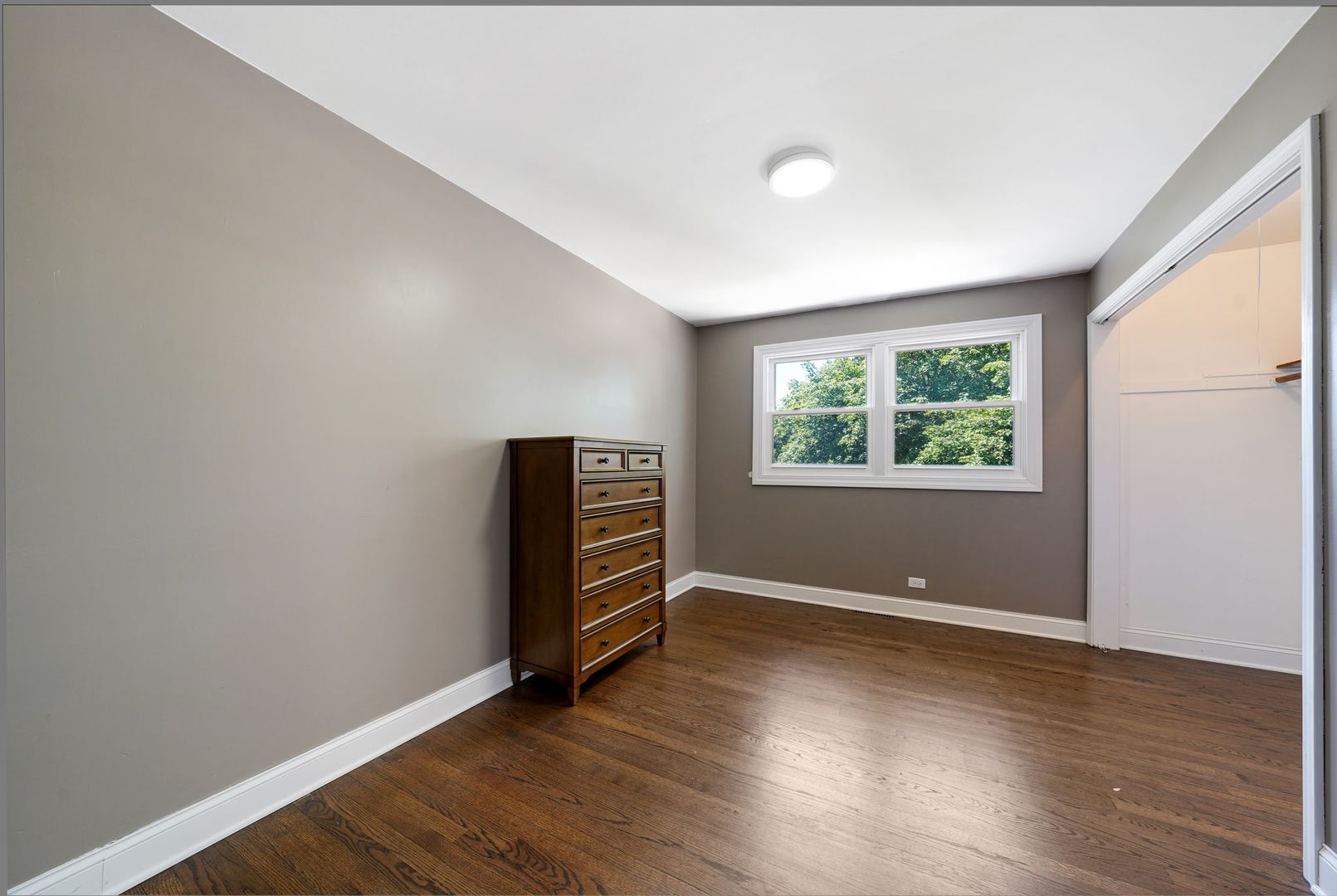 12801 South Ridgeland Avenue Palos Heights, IL 60463 - Photo 35 of 59 an empty room with wooden floor and windows