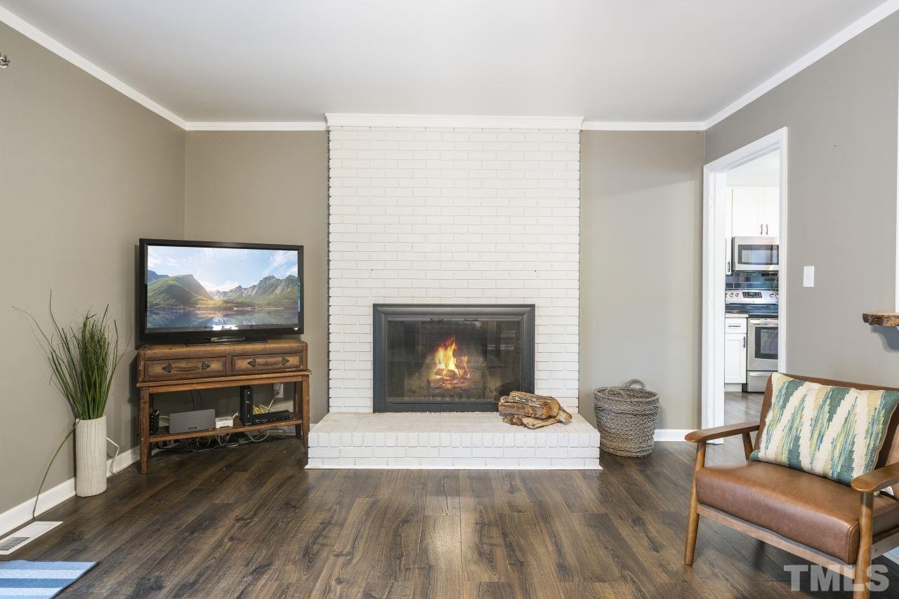 1205 Keith Drive Cary, NC 27511 - Photo 14 of 29 a living room with furniture and a flat screen tv