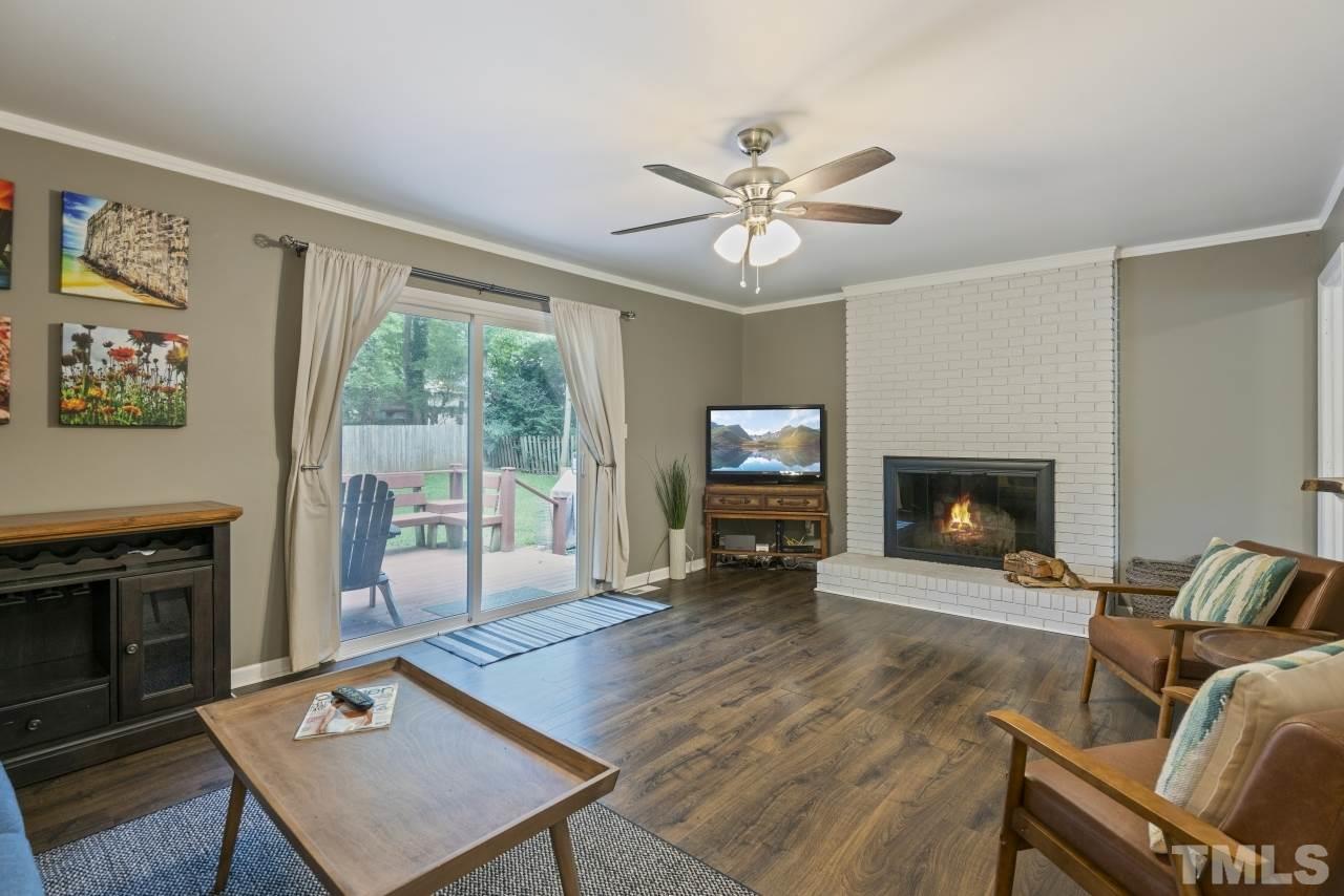 1205 Keith Drive Cary, NC 27511 - Photo 15 of 29 a living room with furniture a fireplace and a flat screen tv