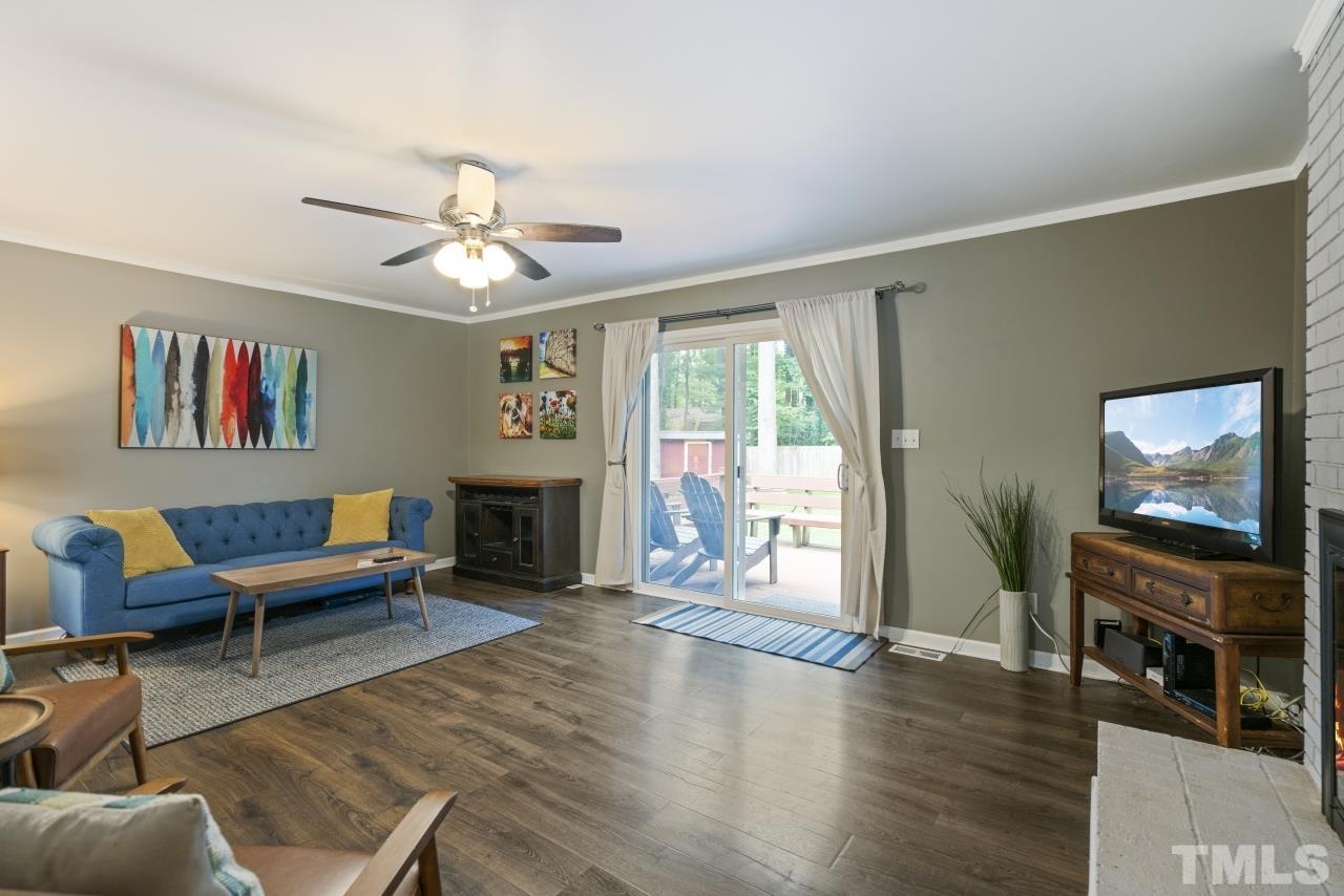 1205 Keith Drive Cary, NC 27511 - Photo 16 of 29 a living room with furniture a fireplace and a flat screen tv