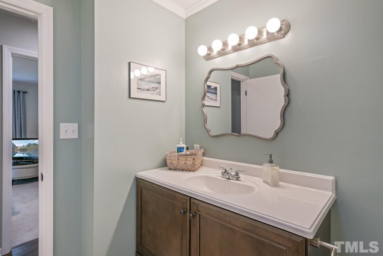 1205 Keith Drive Cary, NC 27511 - Photo 19 of 29 a bathroom with a sink and a mirror
