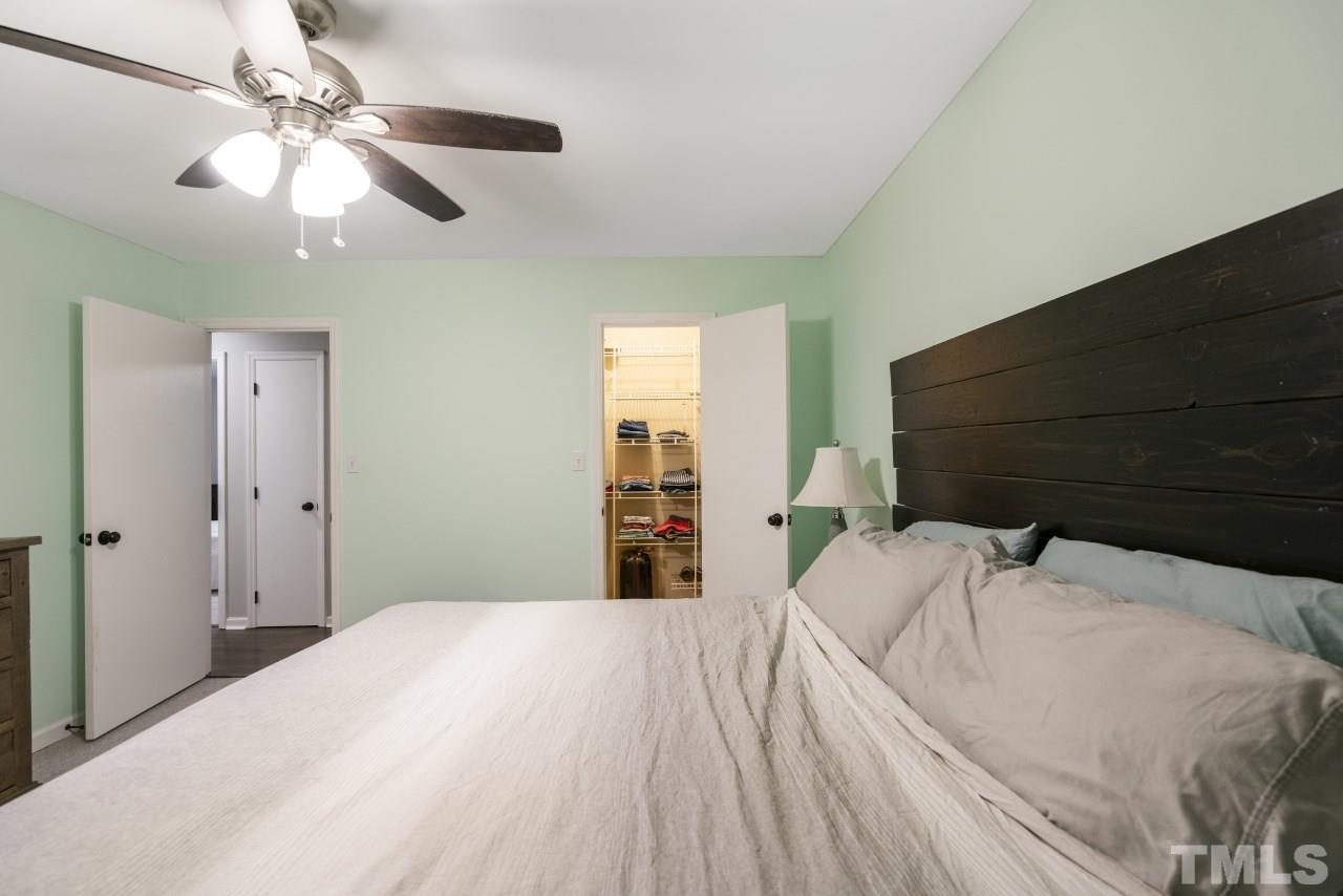 1205 Keith Drive Cary, NC 27511 - Photo 24 of 29 a bedroom with a bed and a ceiling fan
