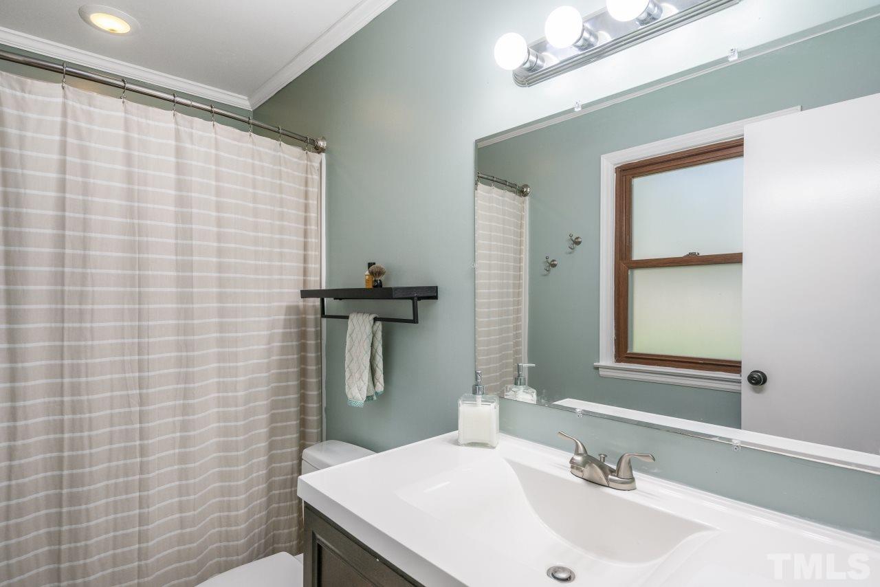 1205 Keith Drive Cary, NC 27511 - Photo 25 of 29 a bathroom with a sink a toilet and mirror