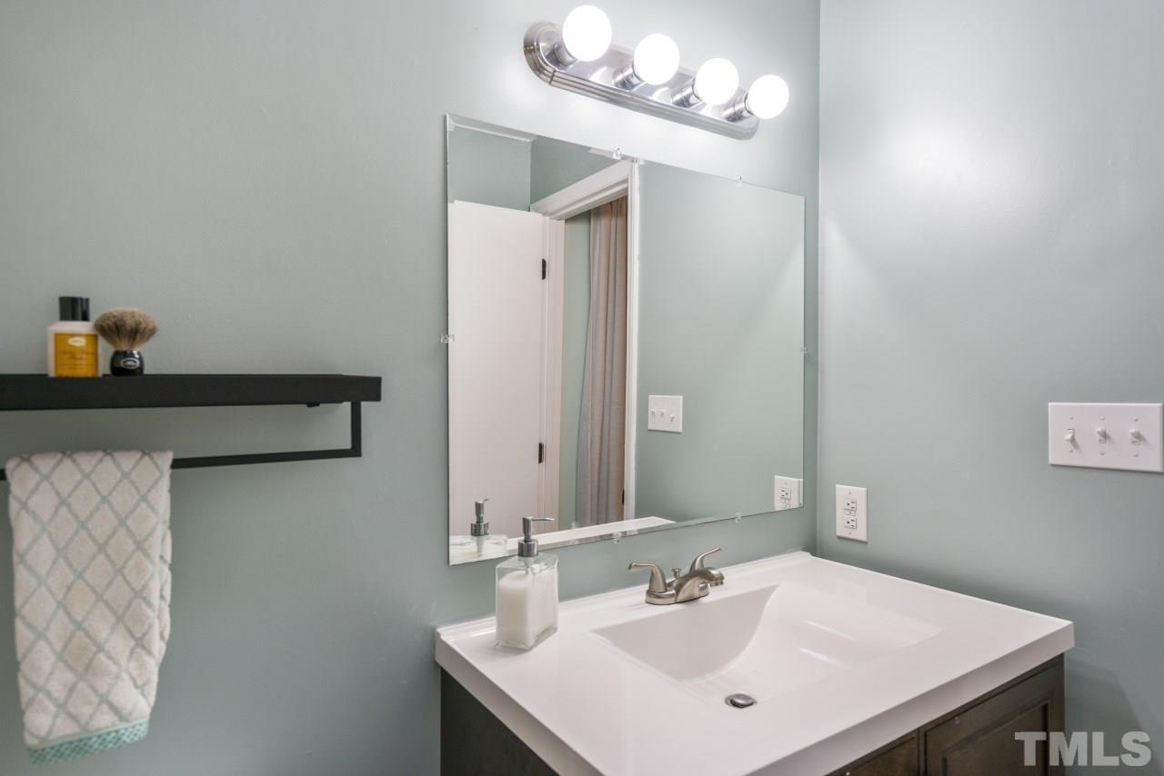 1205 Keith Drive Cary, NC 27511 - Photo 26 of 29 a bathroom with a sink and a mirror