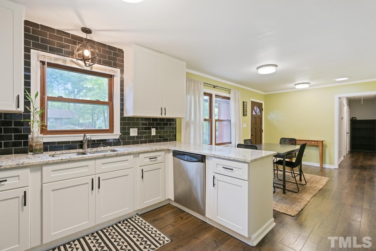 1205 Keith Drive Cary, NC 27511 - Photo 8 of 29 a kitchen with a sink stove and cabinets