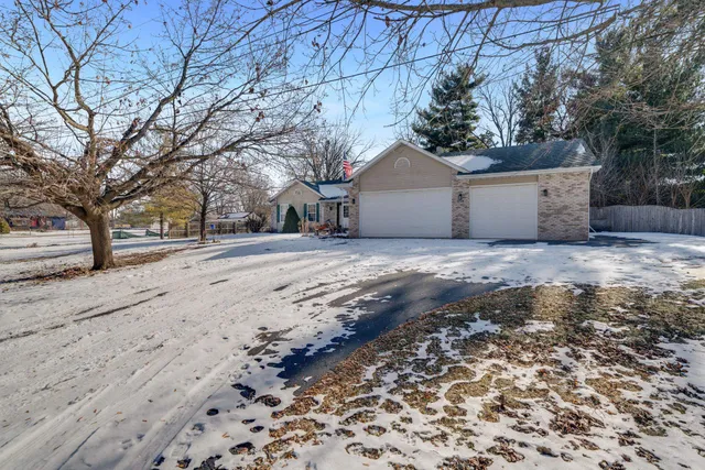 a view of a yard with a house and a snow