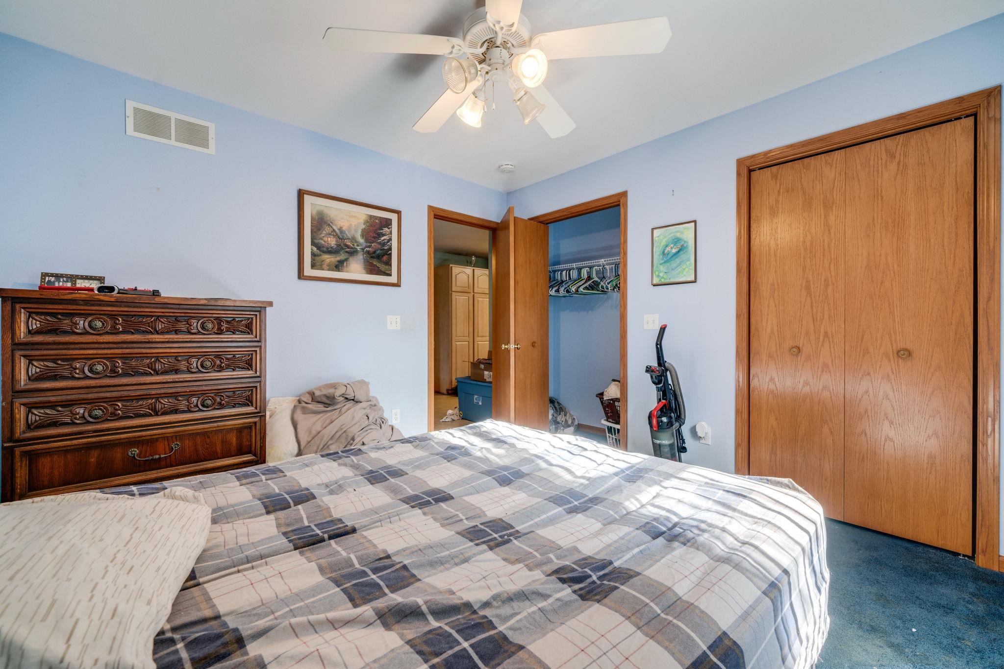3734 Renfro Road Cherry Valley, IL 61016 - Photo 17 of 39 a bedroom with a bed and a chandelier