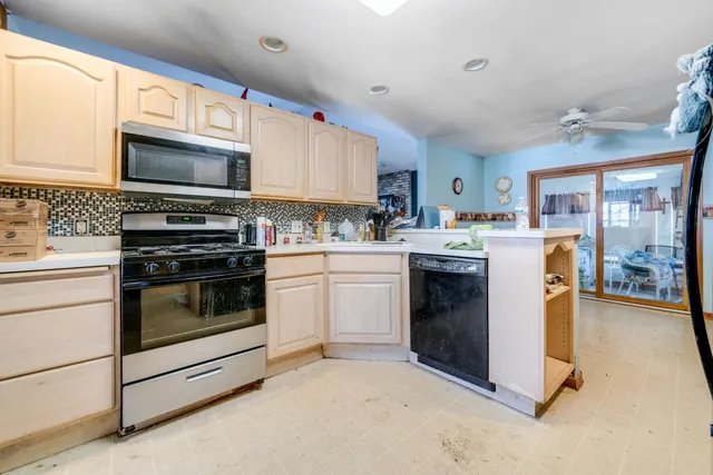 a kitchen with stainless steel appliances a refrigerator and a stove