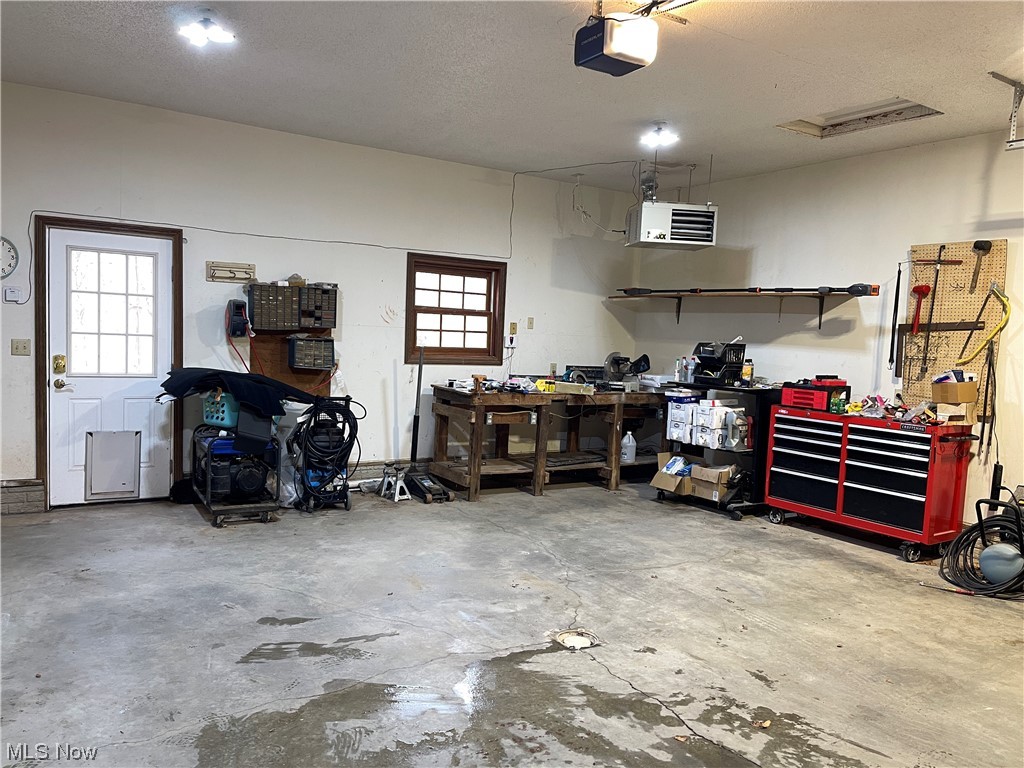720 McGill Road Vincent, OH 45784 - Photo 33 of 50 Garage with a workshop area, heater, and a garage door opener