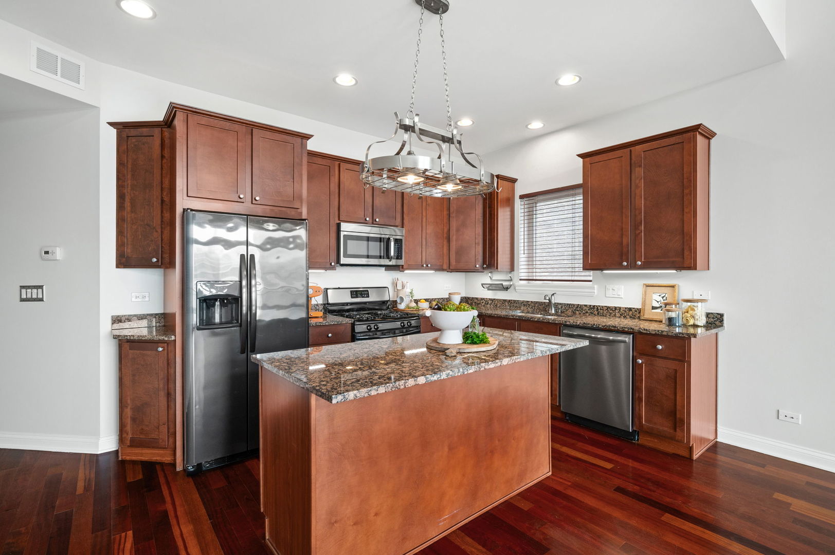 2847 North Pulaski Road, Unit 3S Chicago, IL 60641 - Photo 6 of 25 a kitchen with refrigerator cabinets and wooden floor