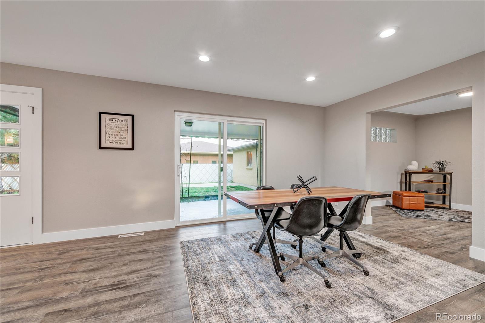 3880 Allison Street Wheat Ridge, CO 80033 - Photo 12 of 25 a view of a dining room with furniture and wooden floor