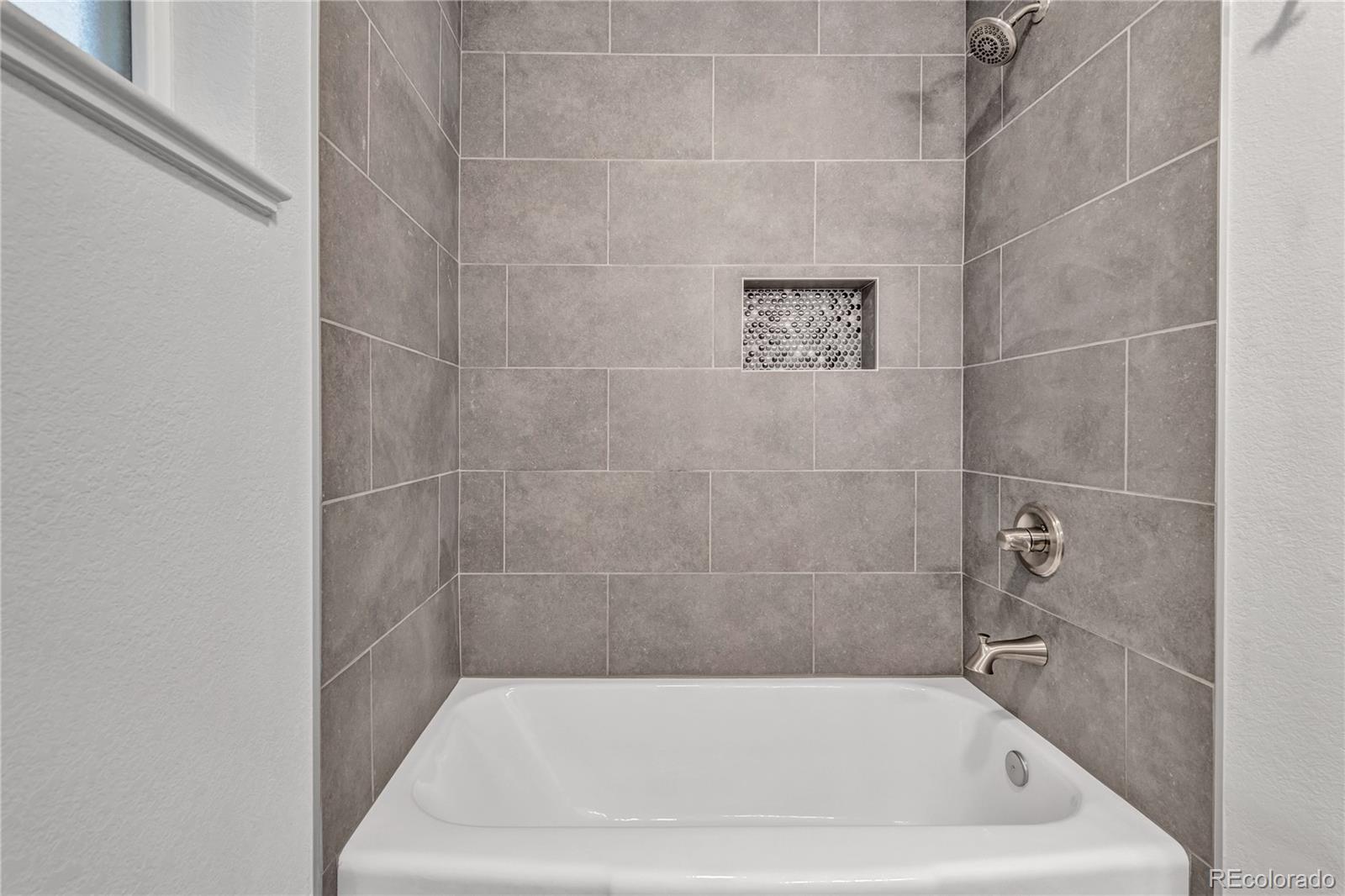 3880 Allison Street Wheat Ridge, CO 80033 - Photo 17 of 25 a bath tub sitting next to a shower