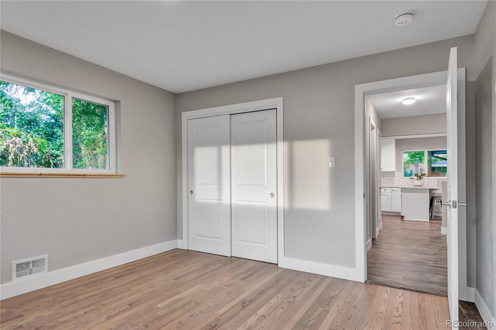 3880 Allison Street Wheat Ridge, CO 80033 - Photo 20 of 25 wooden floor in an empty room with a window