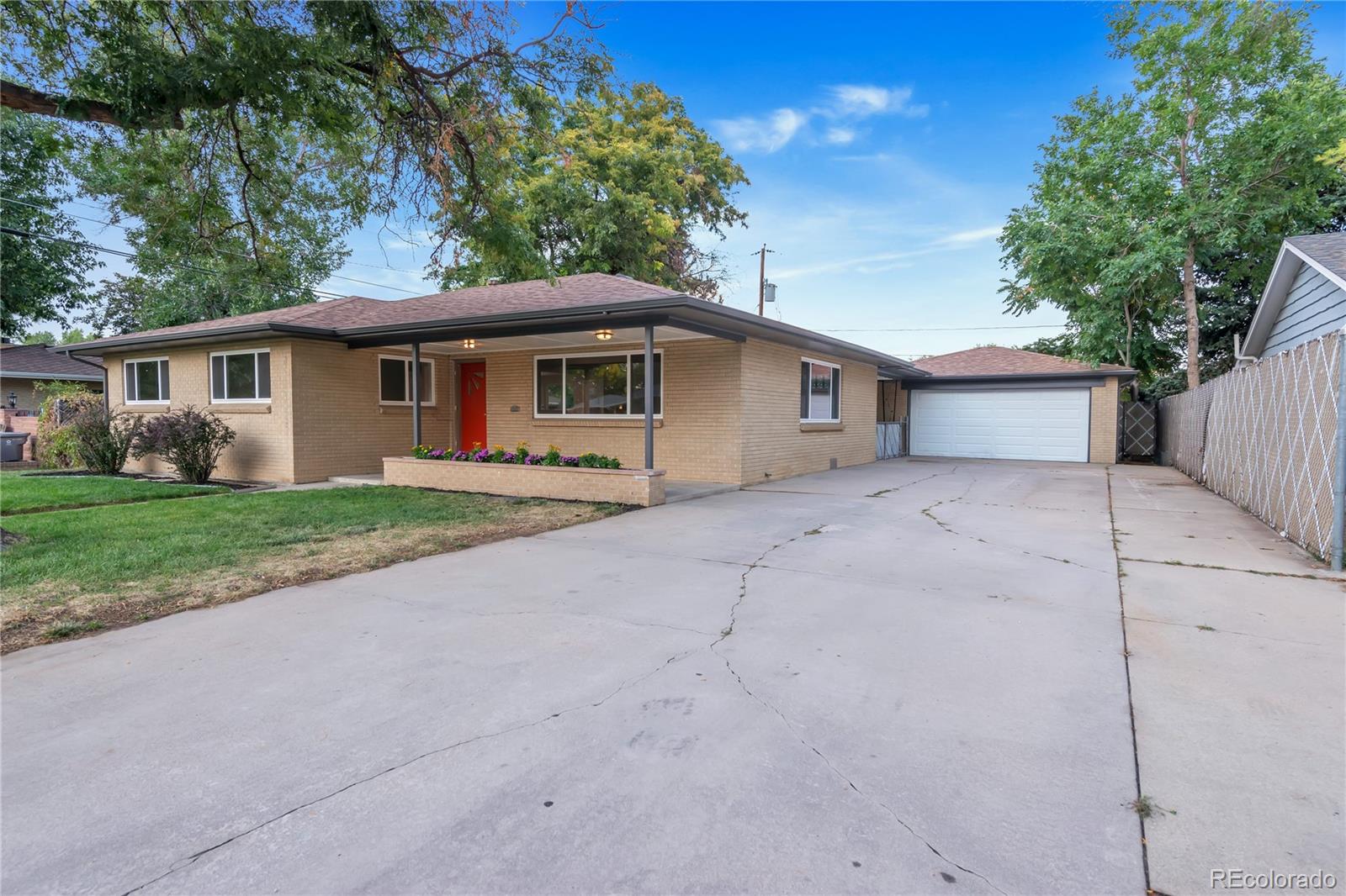 3880 Allison Street Wheat Ridge, CO 80033 - Photo 2 of 25 a front view of a house with yard and green space