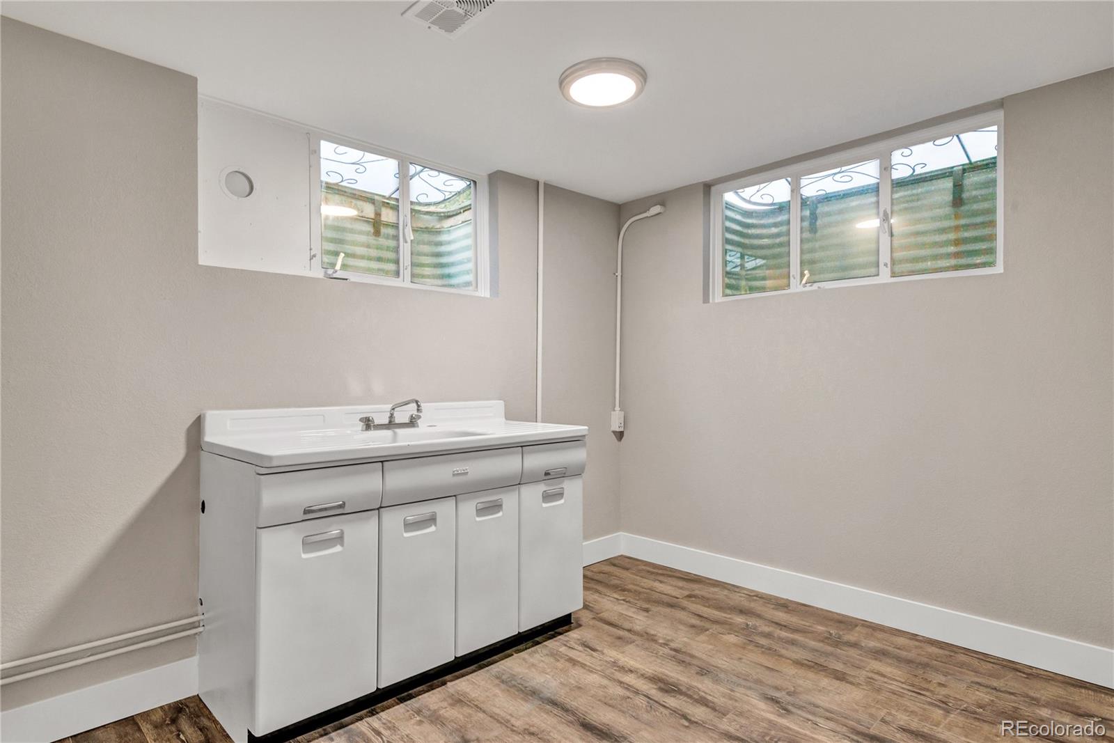 3880 Allison Street Wheat Ridge, CO 80033 - Photo 21 of 25 a utility room with a sink washer and dryer