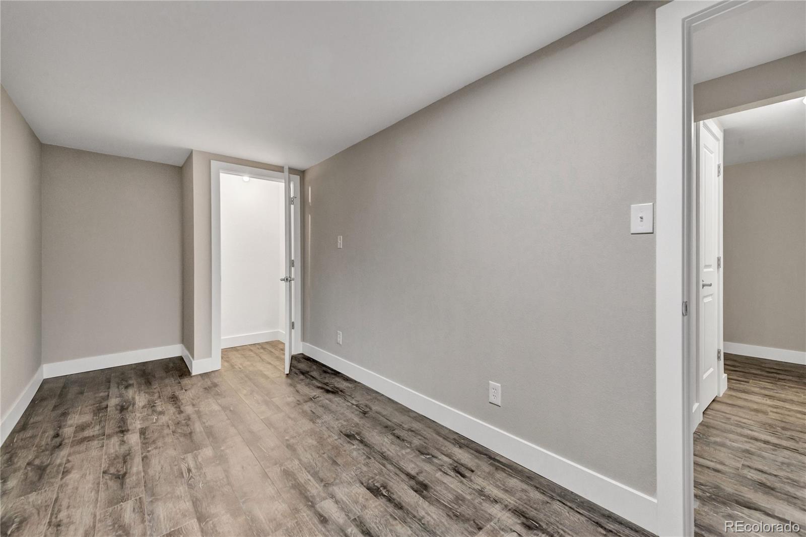 3880 Allison Street Wheat Ridge, CO 80033 - Photo 22 of 25 a view of an empty room with wooden floor