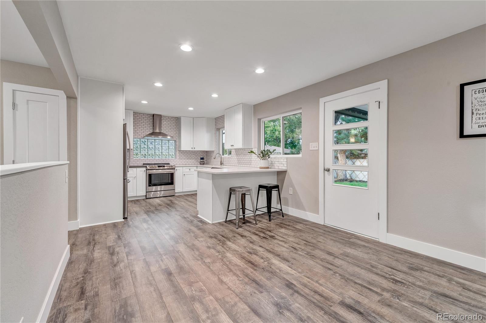 3880 Allison Street Wheat Ridge, CO 80033 - Photo 8 of 25 a kitchen with a table and chairs in it