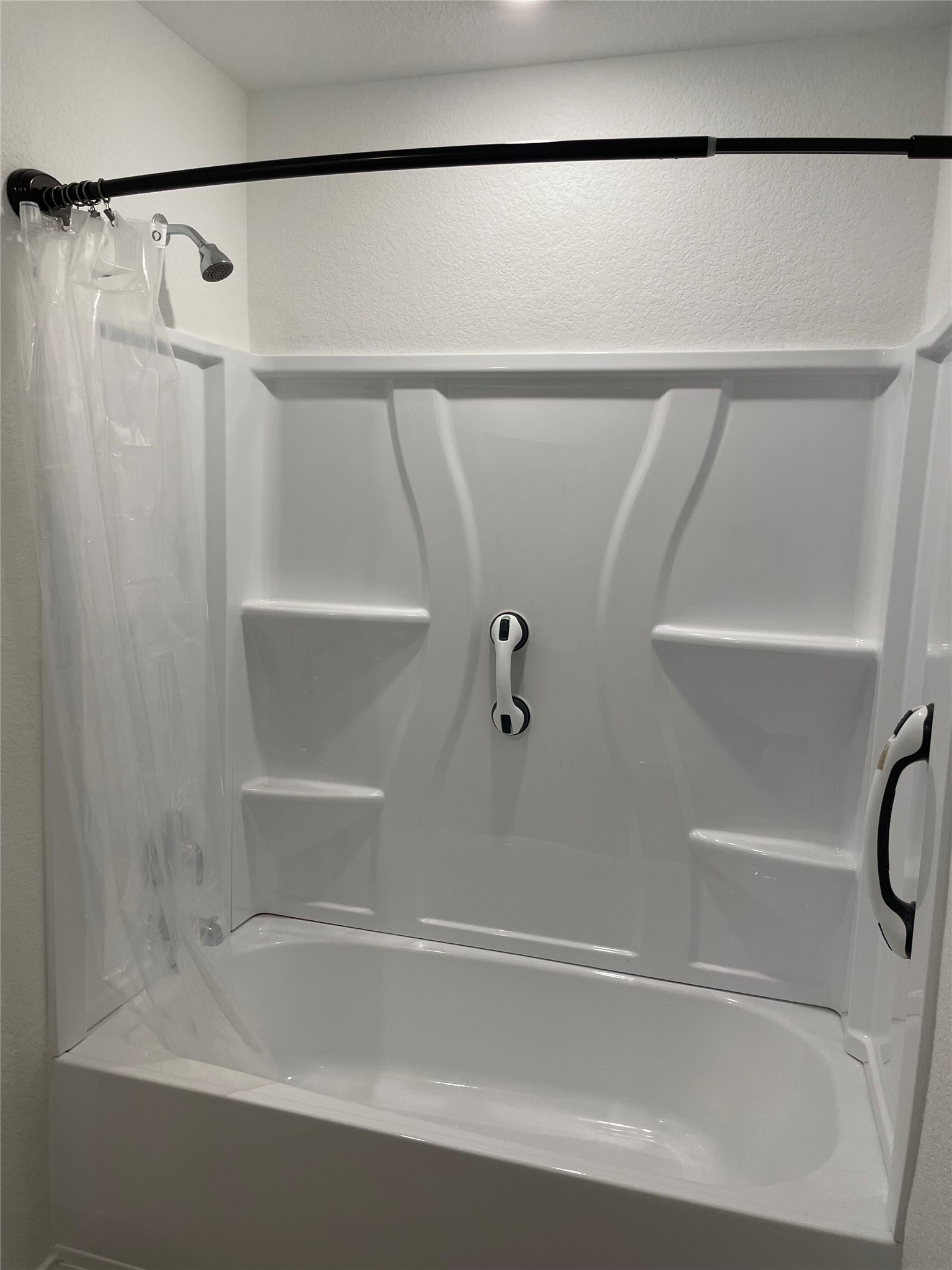 580 Rancho Del Cielo Loop Jarrell, TX 76537 - Photo 16 of 27 a bathroom with a shower and a bath tub