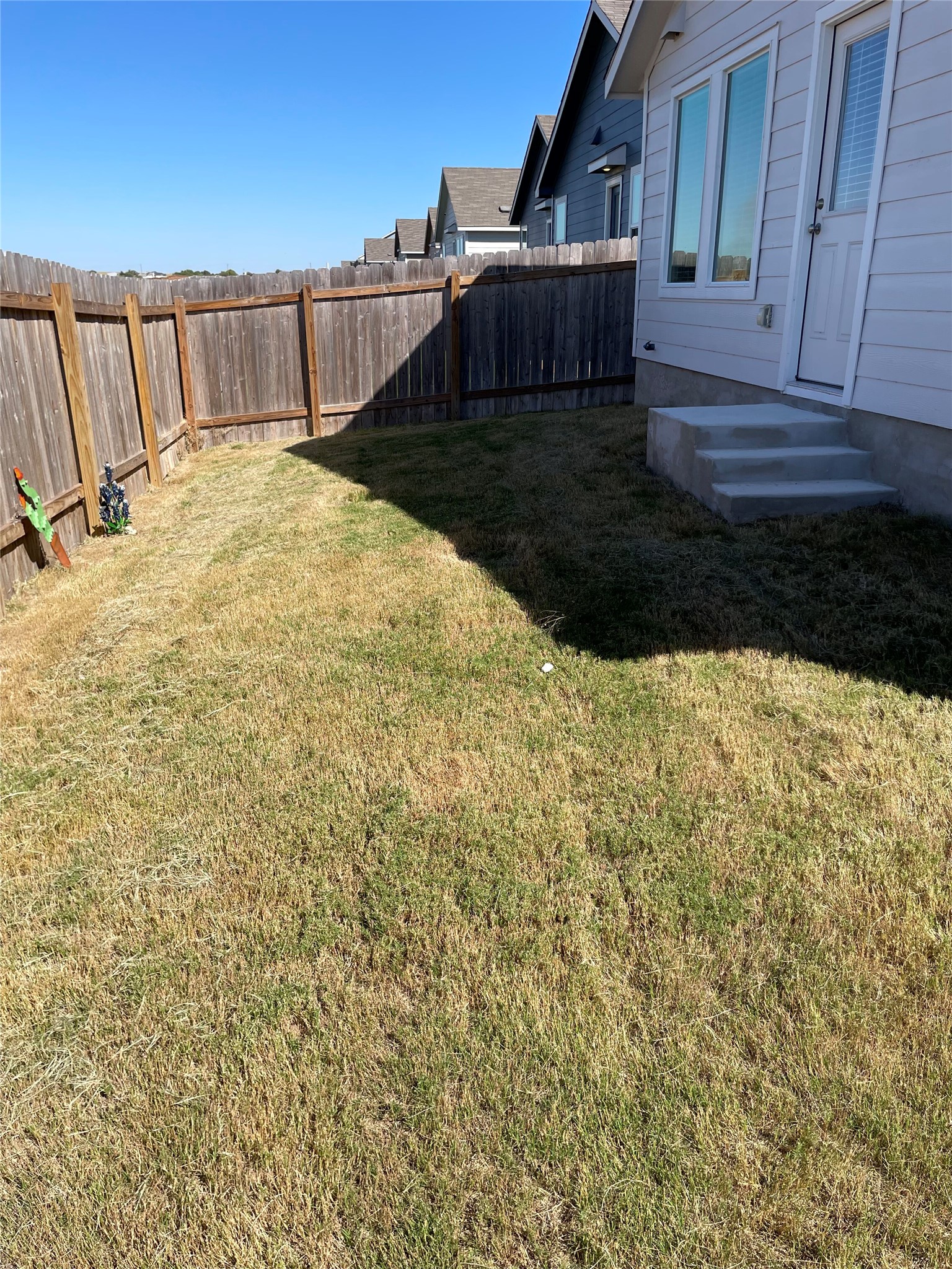 580 Rancho Del Cielo Loop Jarrell, TX 76537 - Photo 19 of 27 a view of a backyard with wooden fence