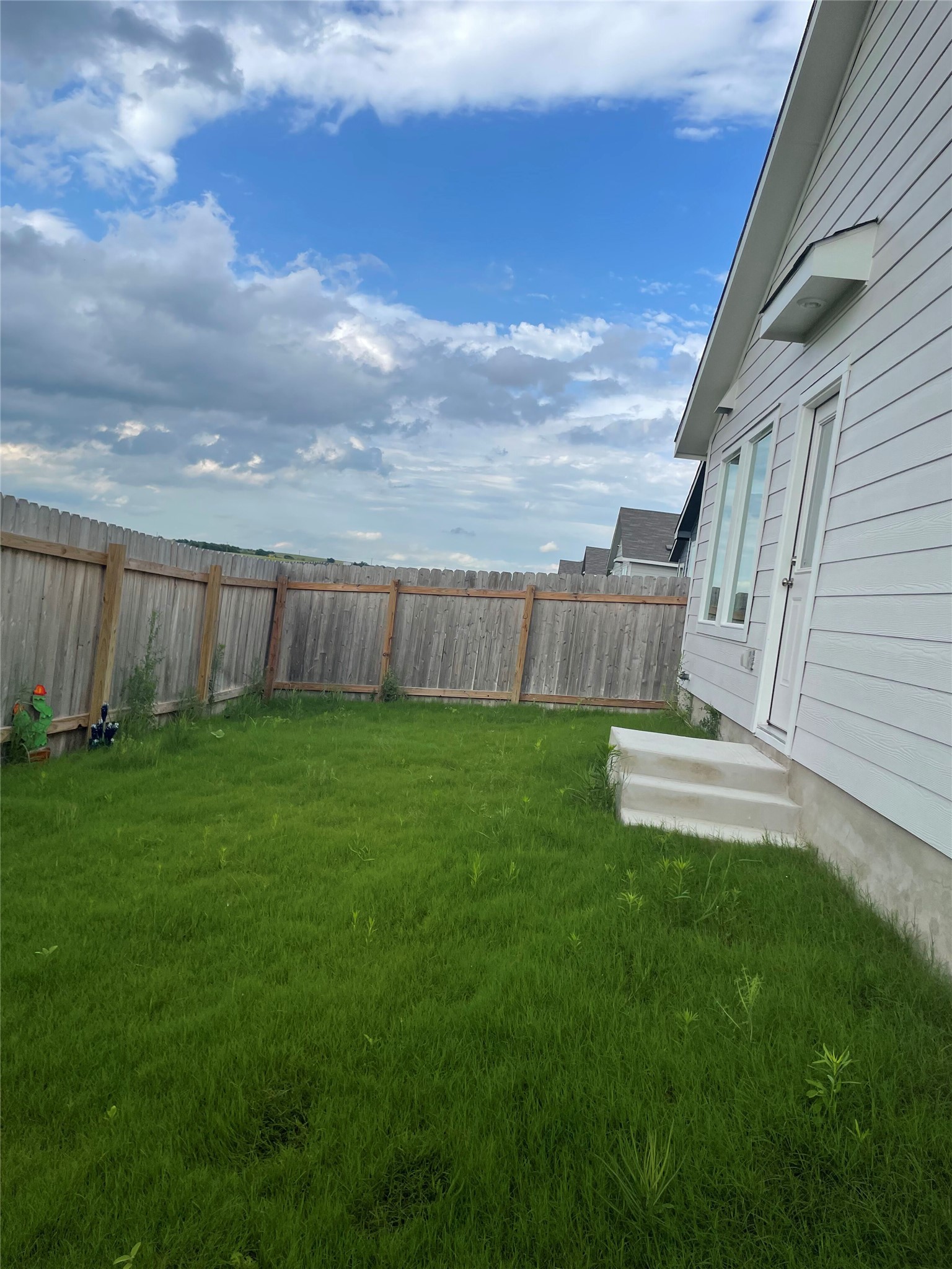 580 Rancho Del Cielo Loop Jarrell, TX 76537 - Photo 22 of 27 a view of a backyard with seating area