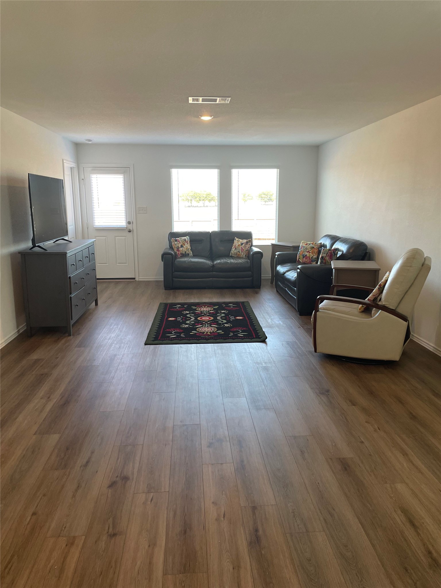 580 Rancho Del Cielo Loop Jarrell, TX 76537 - Photo 7 of 27 a living room with furniture and a wooden floor