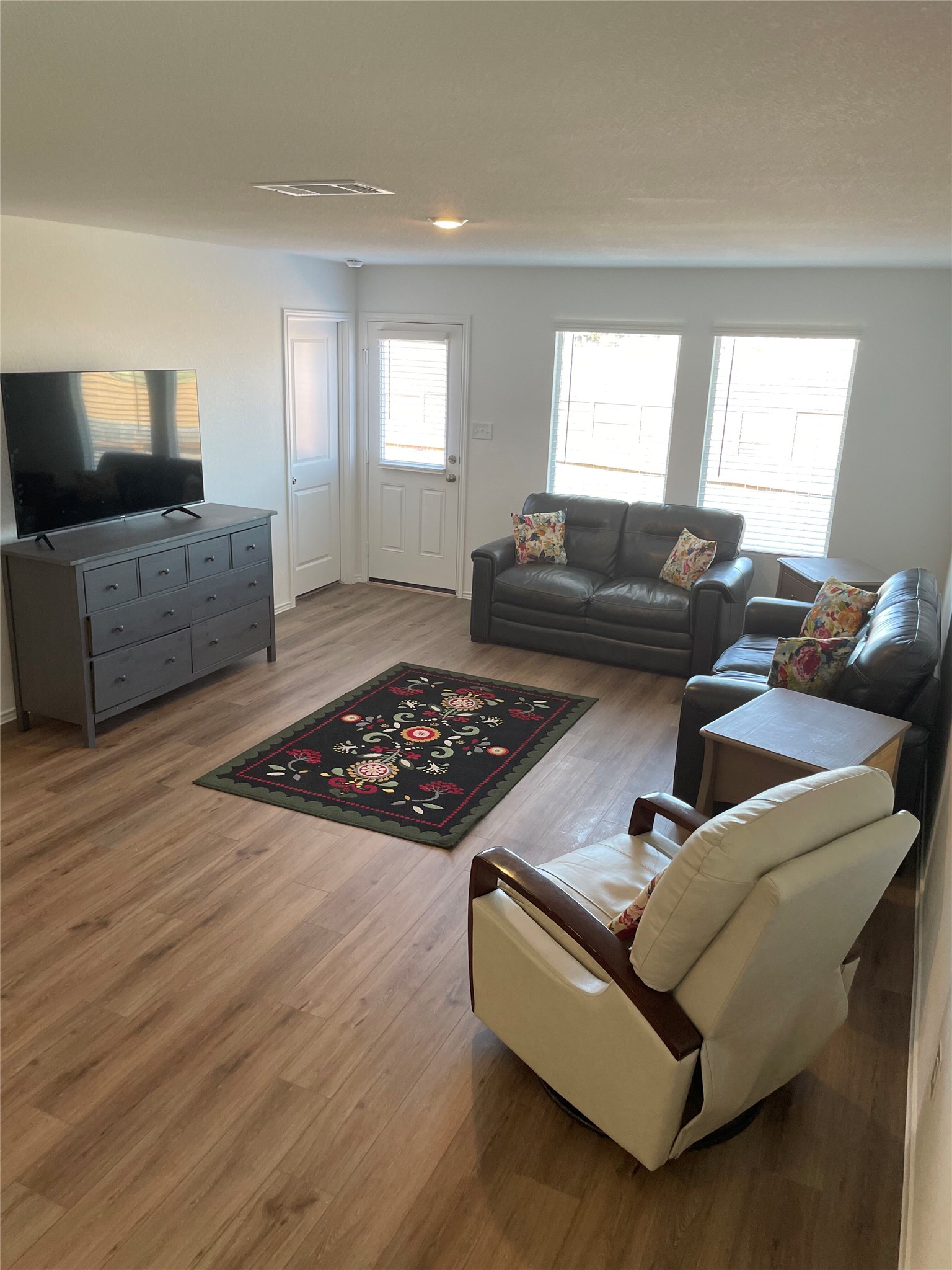 580 Rancho Del Cielo Loop Jarrell, TX 76537 - Photo 8 of 27 a living room with furniture and a flat screen tv