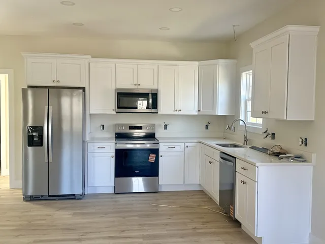 a bathroom with a granite countertop sink a toilet and a mirror