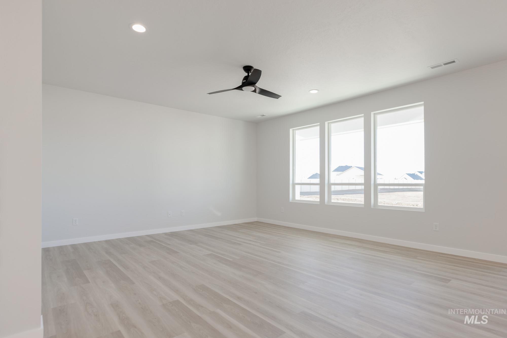 1639 Celina Street Middleton, ID 83644 - Photo 6 of 19 Spacious room featuring light wood-finish flooring, recessed lighting, and a modern ceiling fan