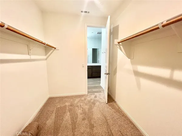 a view of a big room with wooden floor and cabinet