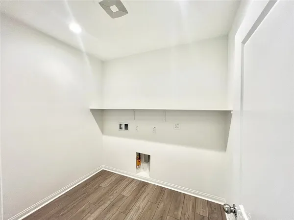 a room with a wooden floor and cabinets