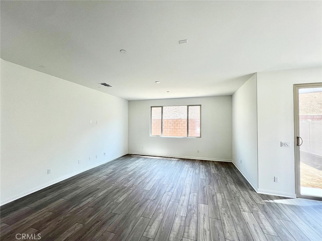 8285 Tristan Lane Riverside, CA 92507 - Photo 19 of 38 an empty room with wooden floor and windows