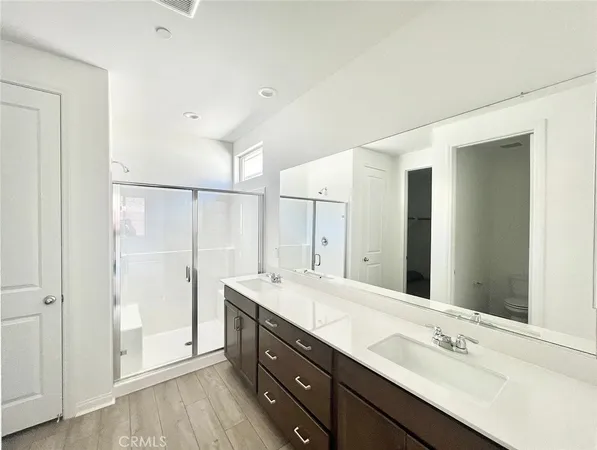 a hallway with wooden floor and cabinet