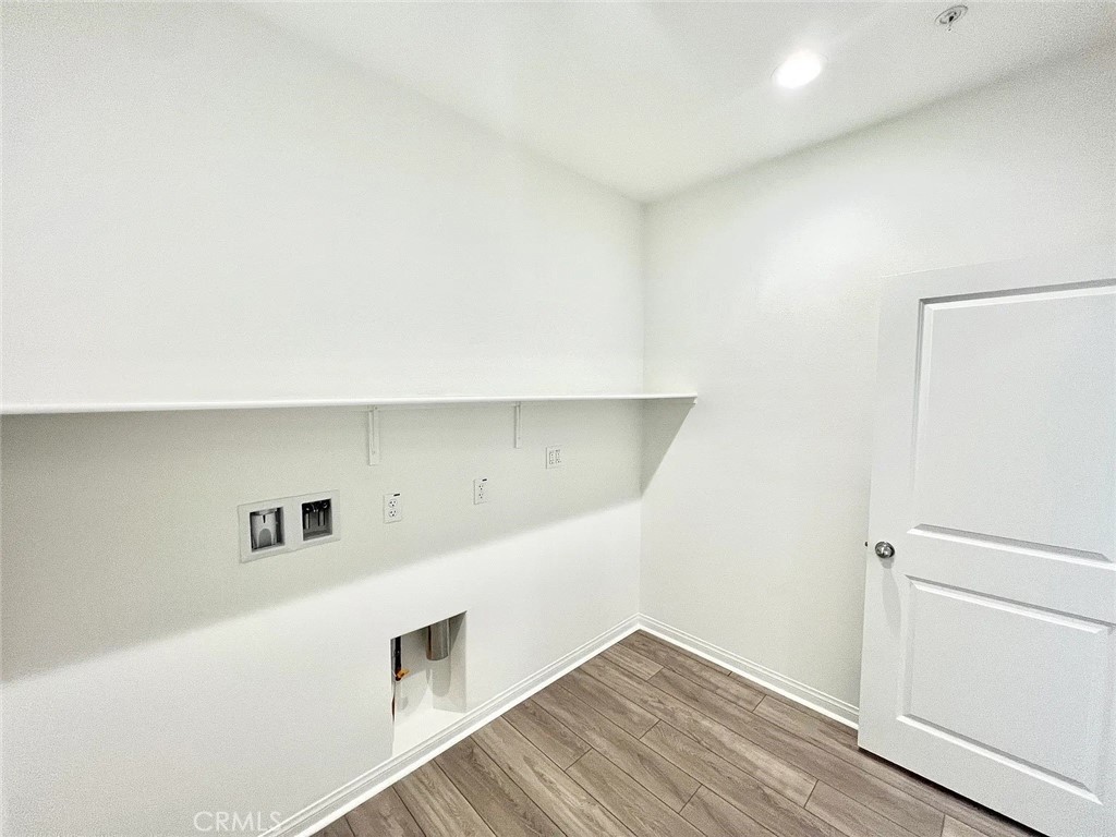8285 Tristan Lane Riverside, CA 92507 - Photo 29 of 38 a hallway with wooden floor and cabinet