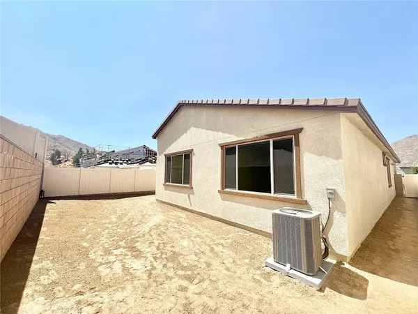 a view of a house with a backyard